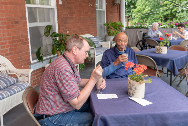 residents having lunch of porch at Vassar Warner Home