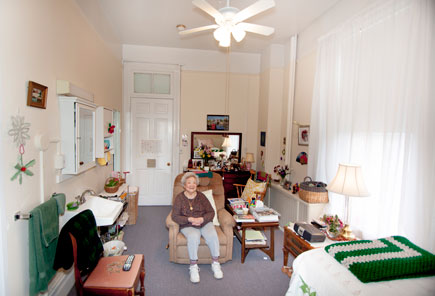 resident sitting in bedroom at Vassar Warner Home