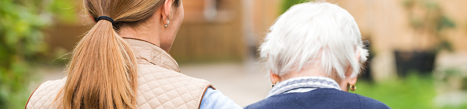 young woman standing next to elderly woman