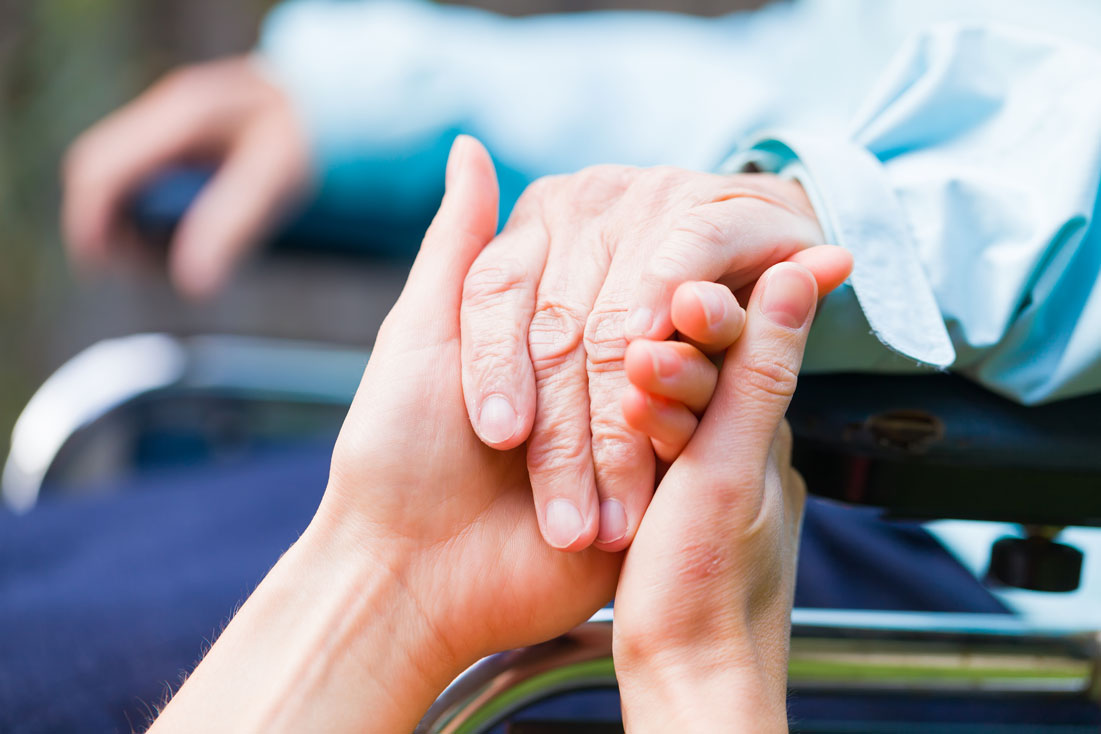 young hands holding elderly hands