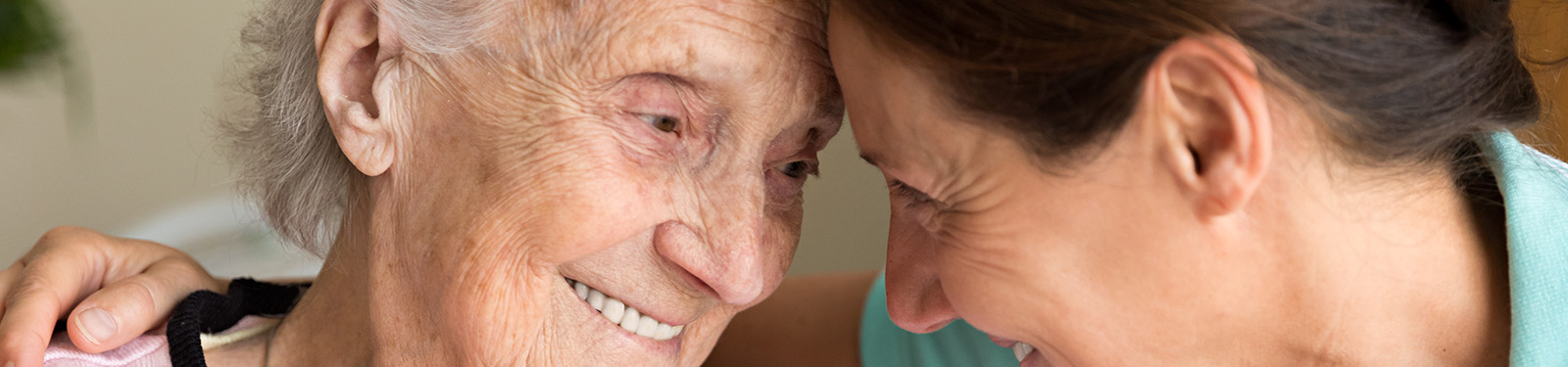 elderly woman looking at young woman