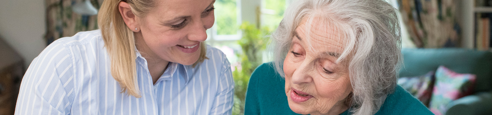 young woman helping elderly woman