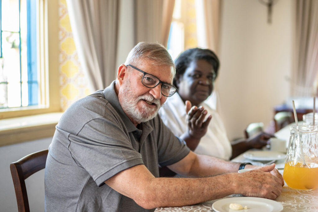 Seniors sitting at lunch table at an adult day care